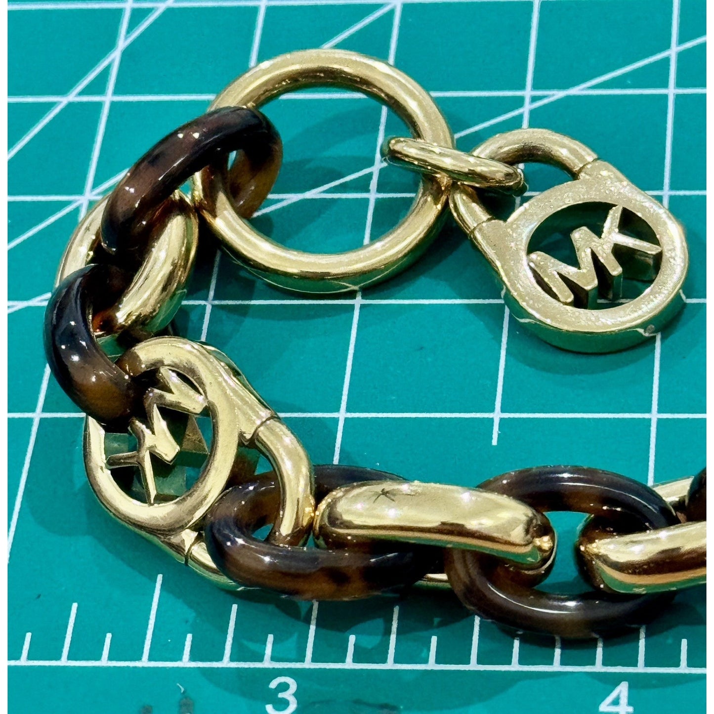 Michael Kors Tortoise Shell And Yellow Gold Tone MK Oval Link Charm Bracelet 8”
