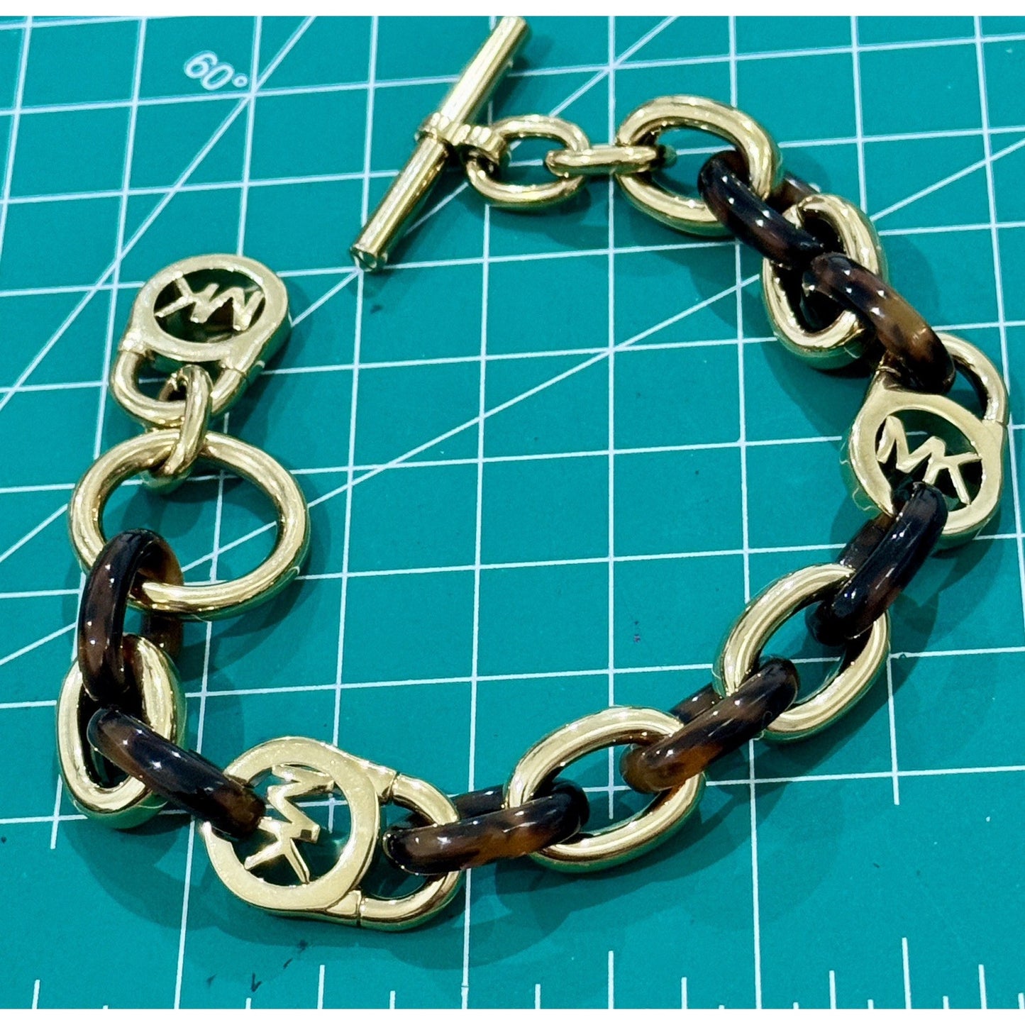Michael Kors Tortoise Shell And Yellow Gold Tone MK Oval Link Charm Bracelet 8”