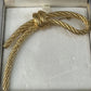 Preowned Vintage New in Box Signed Christian Dior Gold Tone Textured Rope Knot Brooch Pin