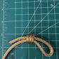 Preowned Vintage New in Box Signed Christian Dior Gold Tone Textured Rope Knot Brooch Pin